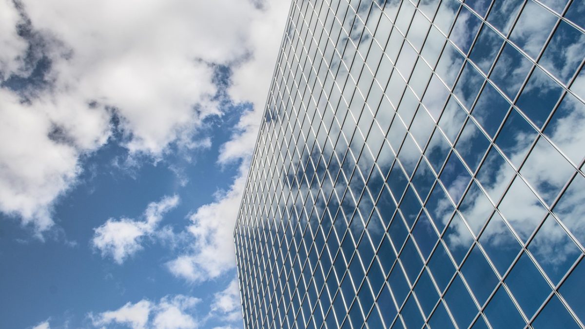 Building, reflection, clouds — Website Design and Development Agency: Full-Service Solutions