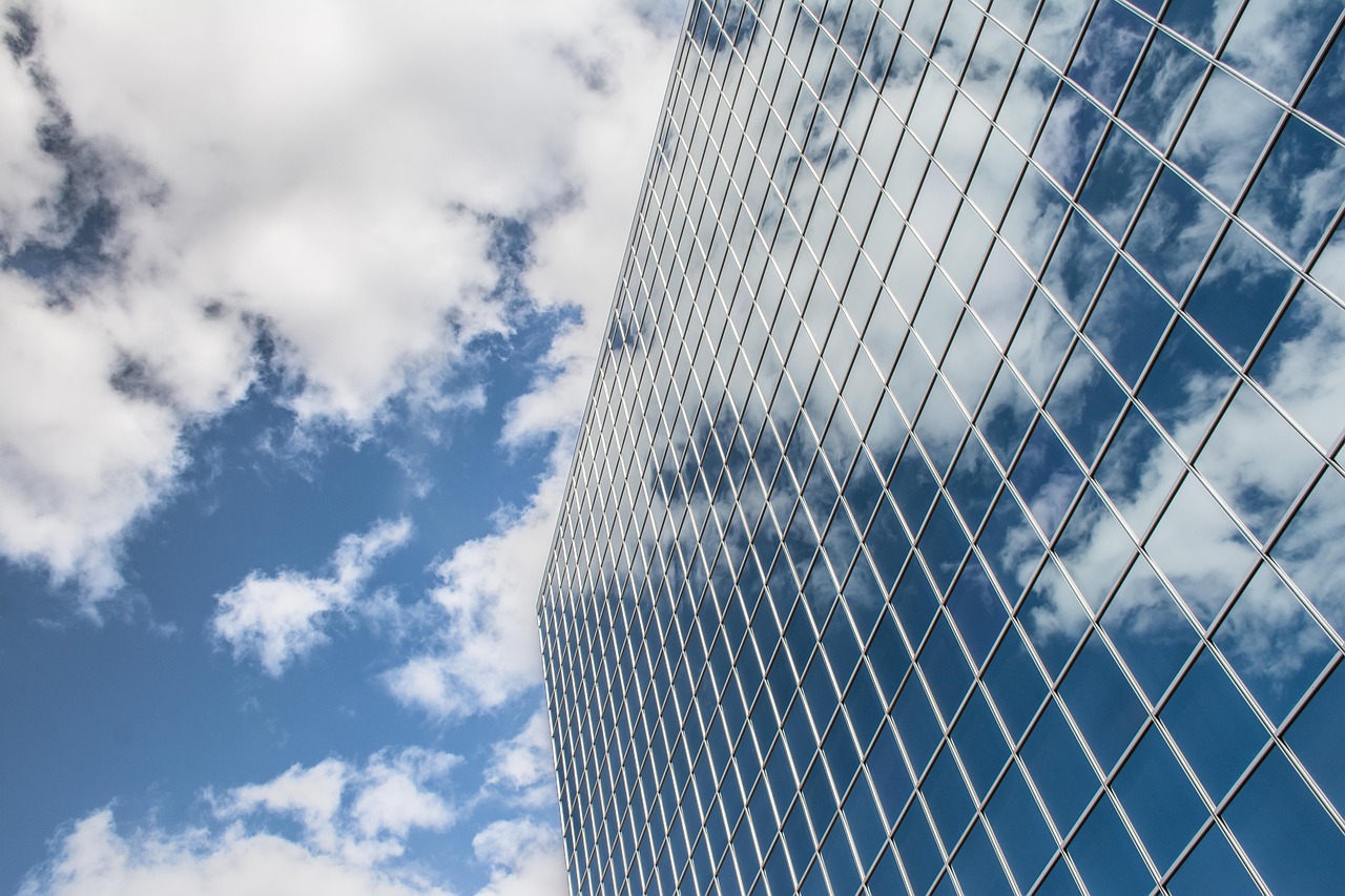 Building, reflection, clouds — Website Design and Development Agency: Full-Service Solutions
