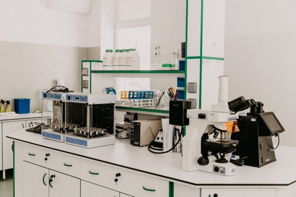Laboratory workspace with scientific equipment and materials for cancer research.